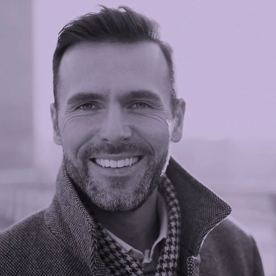 Man smiling confidently after dental implant treatment