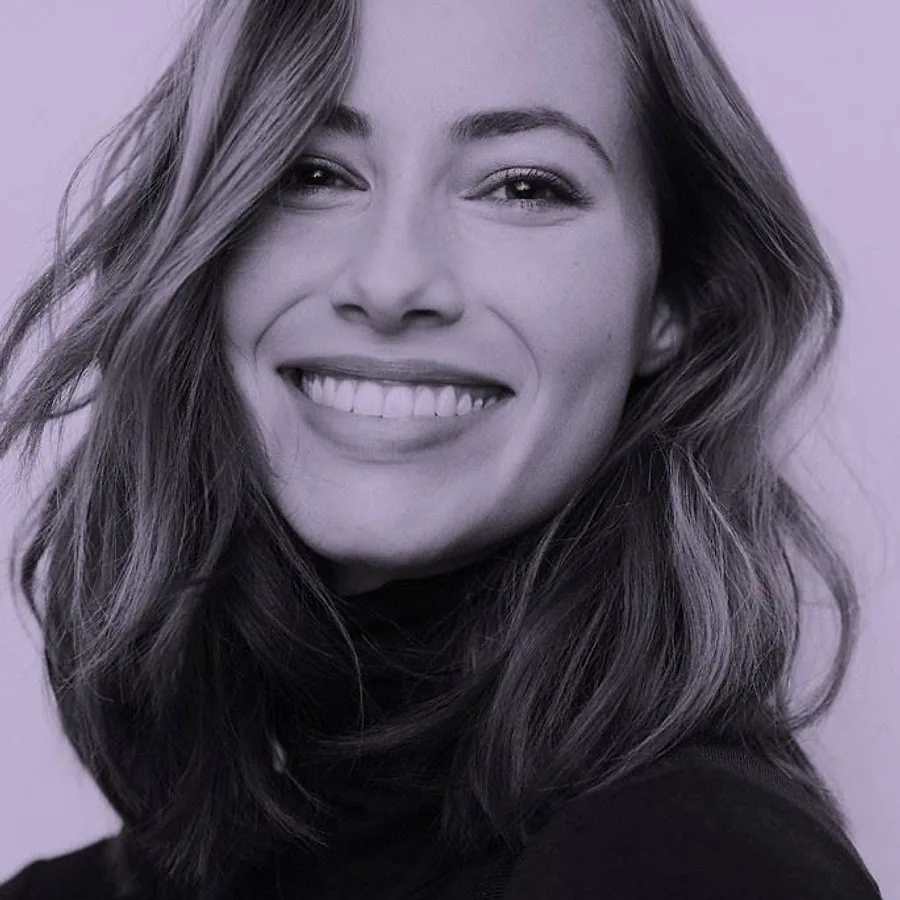 Woman smiling while wearing clear aligners for teeth straightening